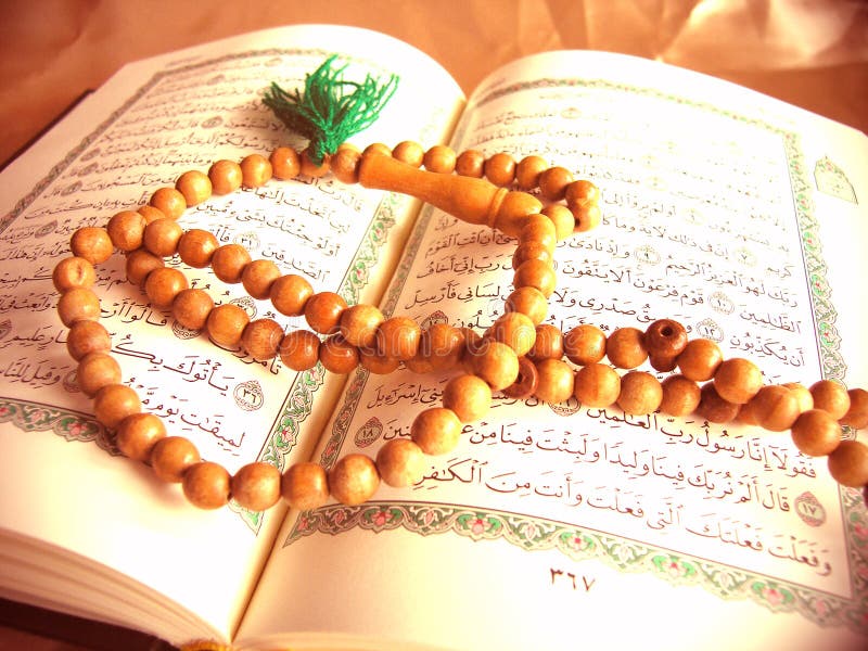 Image of the Noble Qur'an with Dhikr beads resting on top of it. Image of the Noble Qur'an with Dhikr beads resting on top of it.