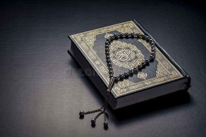 Islamic Book Holy Quran and Beads on Black Background. Islamic Book Holy Quran and Beads on Black Background