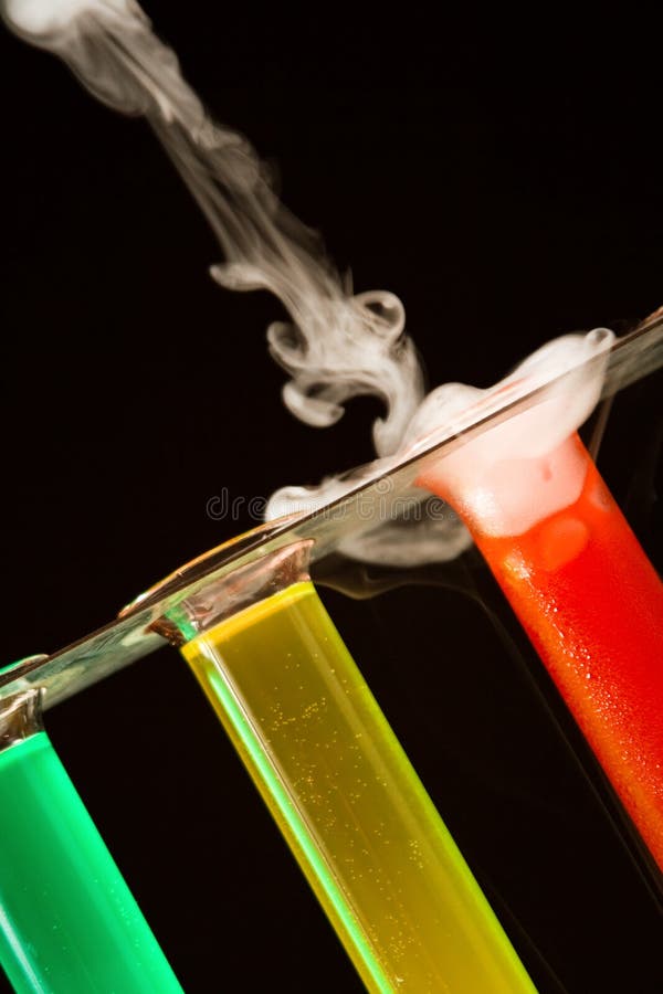 Test tubes in a rack with colored liquids and smoke. Test tubes in a rack with colored liquids and smoke