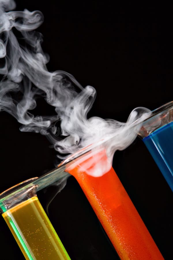 Test tubes in a rack with colored liquids and smoke. Test tubes in a rack with colored liquids and smoke