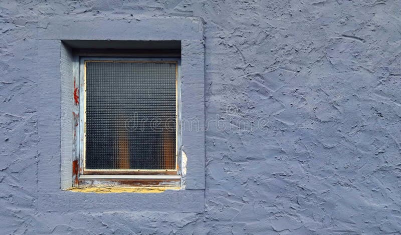 Window on a purple rough stone wall background texture. Window on a purple rough stone wall background texture