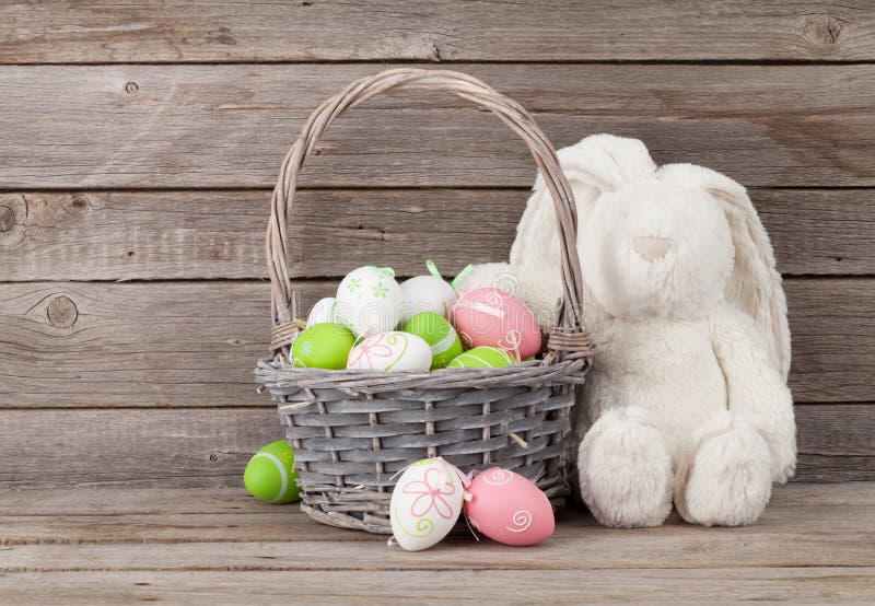 Rabbit toy and easter eggs basket