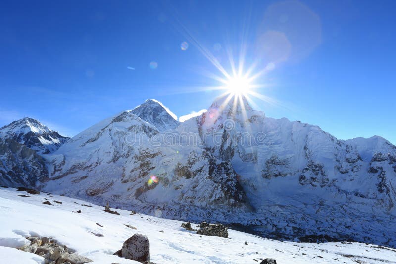 Flare over nuptse summit beside of everest from kallapather summit. Flare over nuptse summit beside of everest from kallapather summit