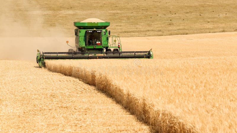 Tetonia, Idaho, USA Aug. 1, 2016 Farm machinery harvesting wheat in the fertile farm fields of Idaho. Tetonia, Idaho, USA Aug. 1, 2016 Farm machinery harvesting wheat in the fertile farm fields of Idaho.