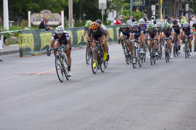 Racers Lead Pack at Uptown Criterium. Minneapolis, United States - June 14, 2013: Racers lead pack at Uptown Criterium in Minneapolis. It is stage four of the royalty free stock image Racers Lead Pack at Uptown Criterium. Minneapolis, United States - June 14, 2013: Racers lead pack at Uptown Criterium in Minneapolis. It is stage four of the royalty free stock image