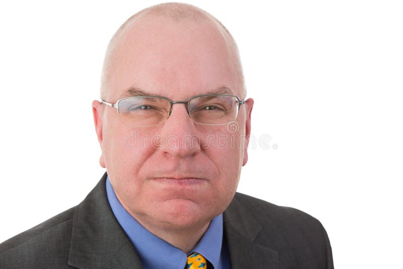 Portrait of an angry revengeful Caucasian middle-aged bald businessman wearing glasses and formal business suit looking at camera with a malicious facial expression, isolated on white background. Portrait of an angry revengeful Caucasian middle-aged bald businessman wearing glasses and formal business suit looking at camera with a malicious facial expression, isolated on white background