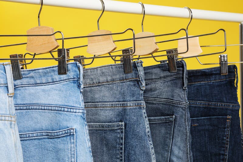 Many Different Blue Jeans On A Hanging Rack In The Clothes Shop Store ...