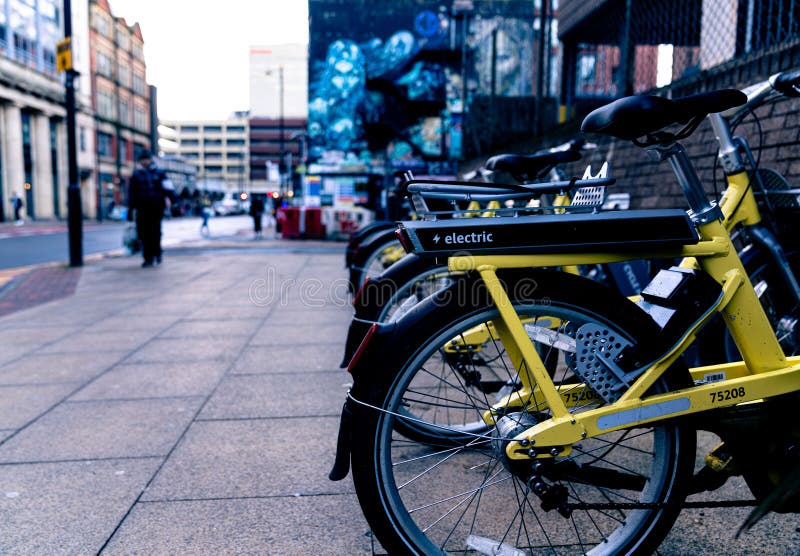 Rack of E Bikes Ready To Use in City Centre. Editorial Photography