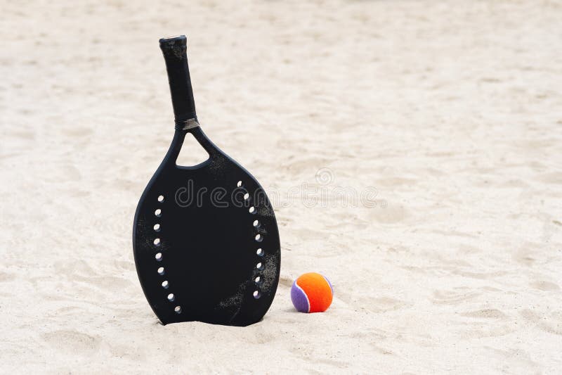 Racket and Ball on the Sandy Beach. Summer Sport Concept Stock Photo ...