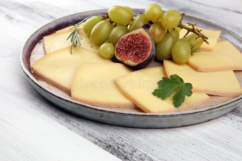 Raclette Cheese Sliced. Very Delicious Swiss Raclette on Rustic