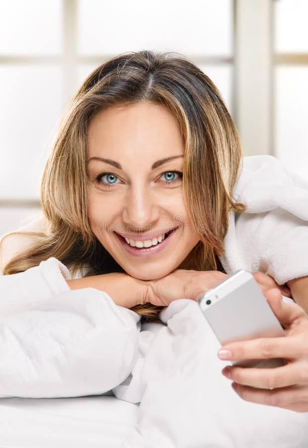 Radiant Woman With Phone Lying On Bed Stock Image Image Of Beauty Messaging 55878829 