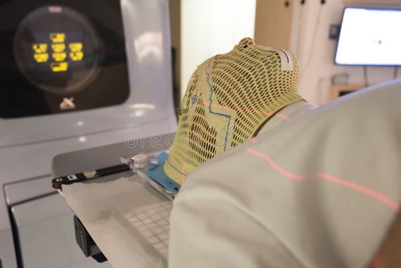 Patient Radiation therapy mask showing laser lines for targeting cancer cells in the brain