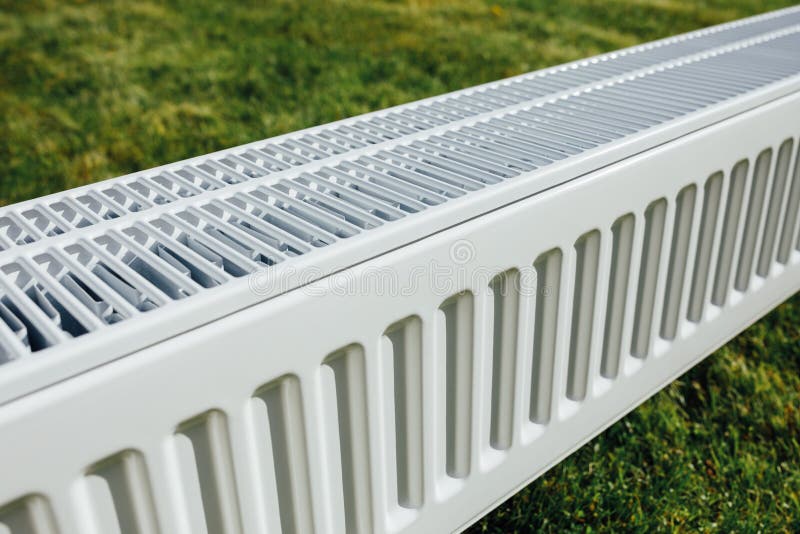 Radiator on Green Lawn, Ecological Heating Concept Stock Photo Image