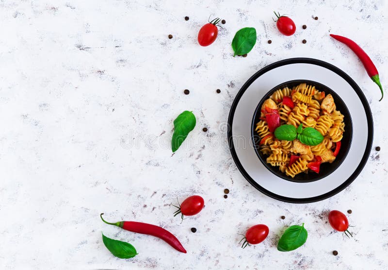 Radiatori Pasta with Chicken and Peppers on White Background. Top View
