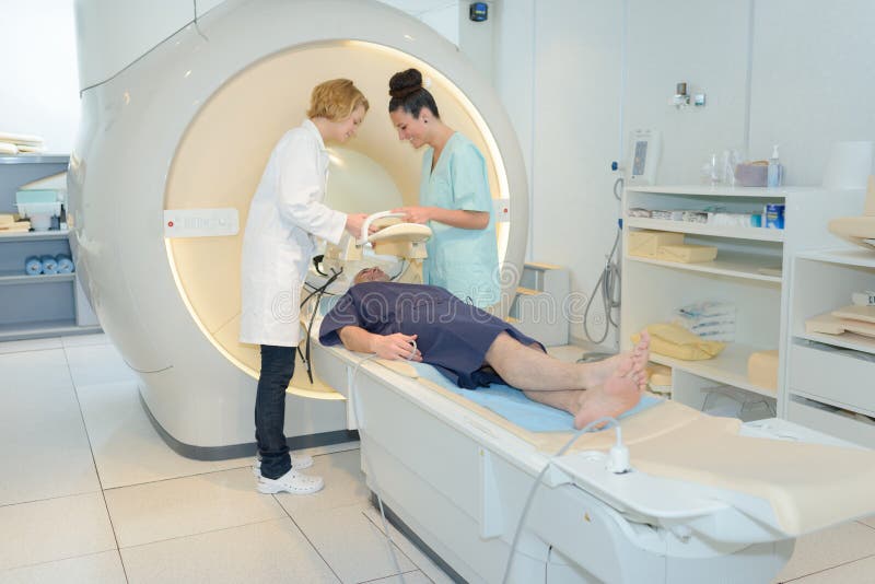 radiologic technicians and patient being scanned and diagnosed on doctor. radiologic technicians and patient being scanned and diagnosed on doctor