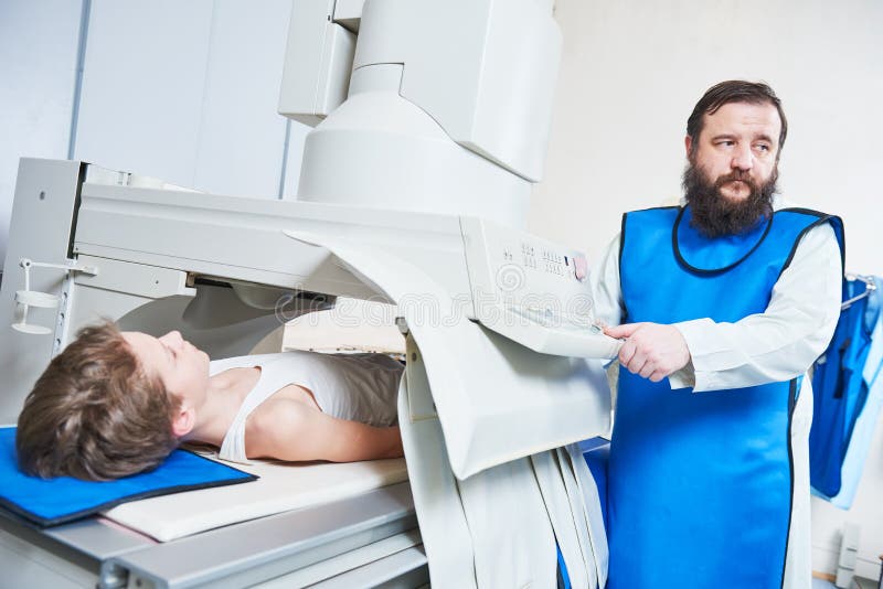 Radiology specialist. Male radiologist in protective wear with little boy preparing or x-ray radiography. Radiology specialist. Male radiologist in protective wear with little boy preparing or x-ray radiography