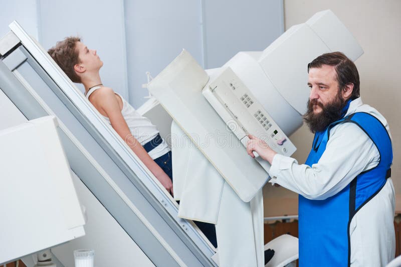 Radiology specialist. Male radiologist in protective wear with little boy preparing or x-ray radiography. Radiology specialist. Male radiologist in protective wear with little boy preparing or x-ray radiography