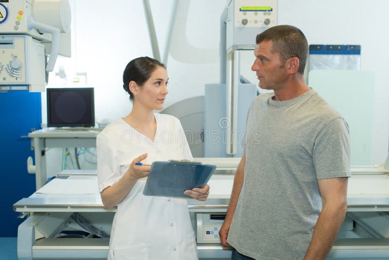 Radiologist with Nurse Preparing Patient for Xray Stock Photo Image