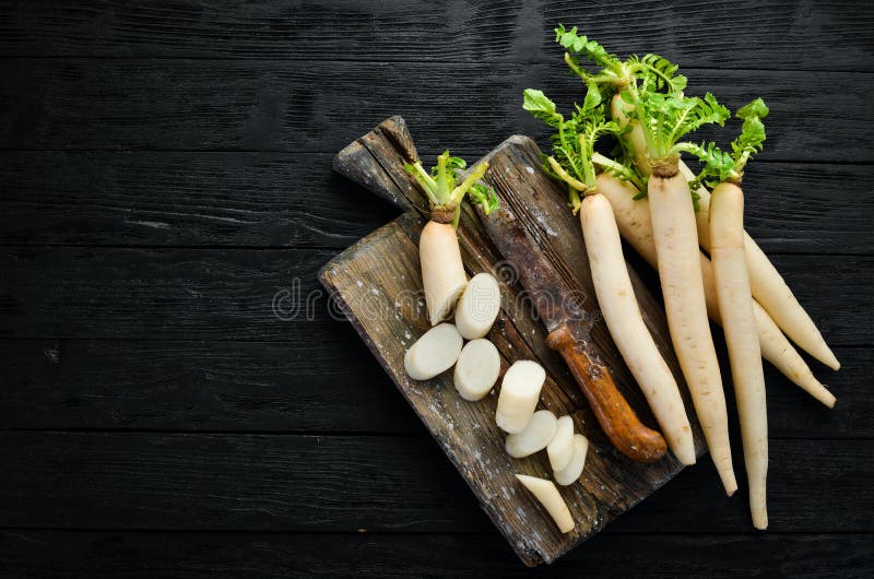 Daikon on a Black Background. Large Root, Japanese Radish Stock Photo