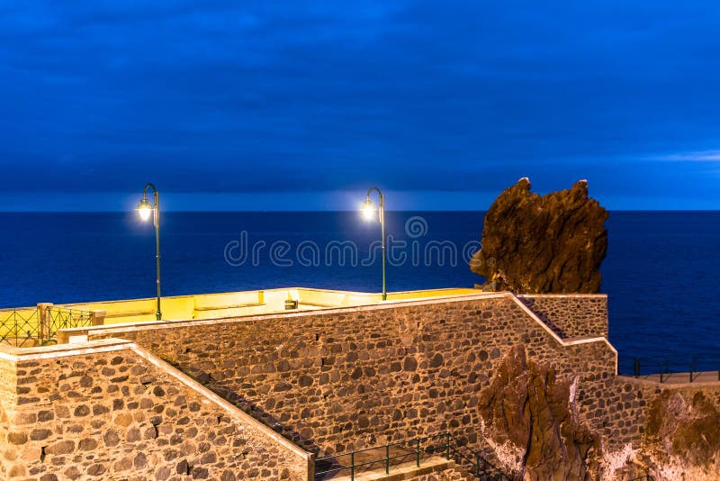 ocean cliff with concrete and stone walls to protect geometries and colorful architectures in Ponta do Sol Madeira Portugal. ocean cliff with concrete and stone walls to protect geometries and colorful architectures in Ponta do Sol Madeira Portugal