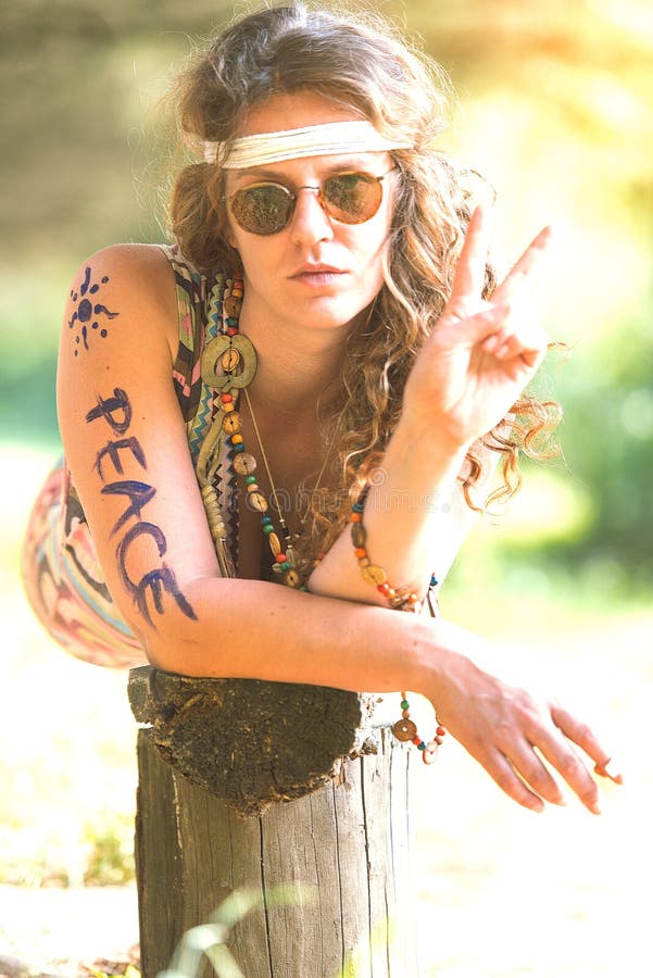 Pretty free hippie girl. Peace. Body painting. Outdoor in peace and free love. Top view - Vintage effect photo. Pretty free hippie girl. Peace. Body painting. Outdoor in peace and free love. Top view - Vintage effect photo