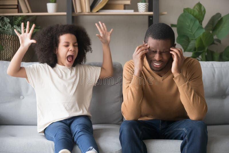 Stubborn noisy african child girl in tantrum screaming at annoyed tired black father, naughty kid daughter with attention deficit yelling, manipulation, family fight, parents and children conflict. Stubborn noisy african child girl in tantrum screaming at annoyed tired black father, naughty kid daughter with attention deficit yelling, manipulation, family fight, parents and children conflict