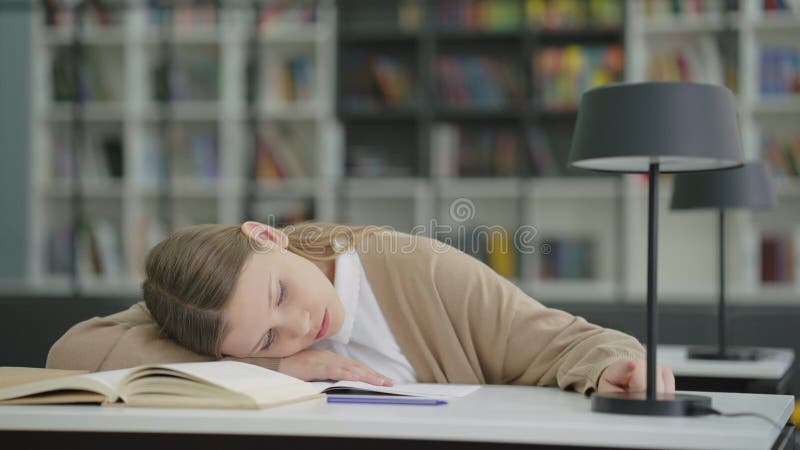 Ragazza che gioca con la lampada tattile durante la lezione noiosa