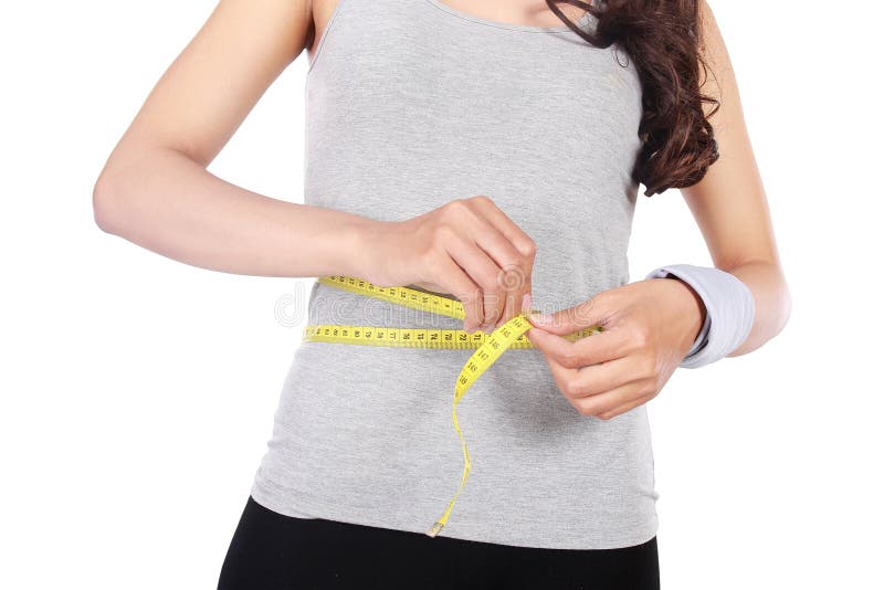 Ragazza con il centimetro nel concetto stante a dieta immagini stock Ragazza con il centimetro nel concetto stante a dieta immagini stock