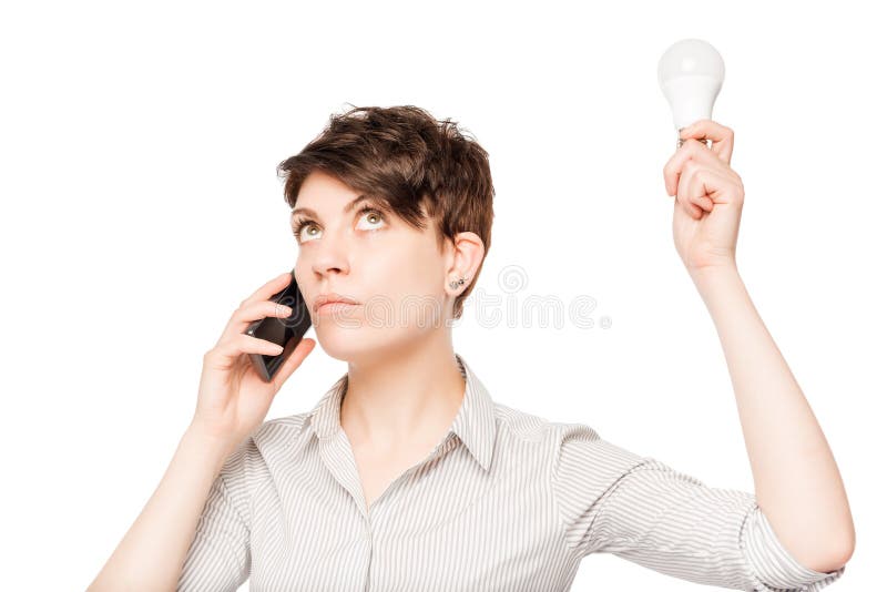 Ragazza con il telefono e la lampada nella posa delle mani fotografia stock Ragazza con il telefono e la lampada nella posa delle mani fotografia stock