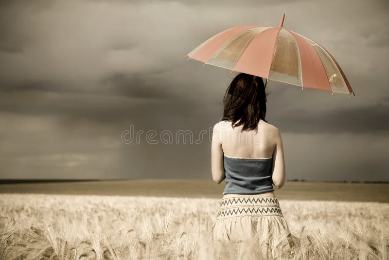 Girl with umbrella at field. Photo in retro style #1. Girl with umbrella at field. Photo in retro style #1