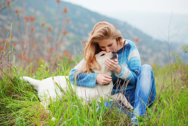 Girl with her dog resting outdoors. Girl with her dog resting outdoors