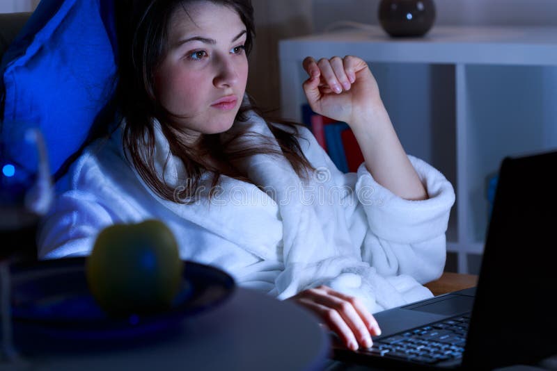 Girl addicted to social media using laptop at night. Girl addicted to social media using laptop at night