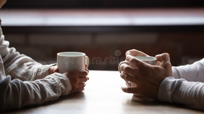 Close up women and men sitting in cafe, holding warm cups of coffee on table, young couple spending weekend in cozy coffeehouse together, romantic date concept, visitors drinking hot beverages. Close up women and men sitting in cafe, holding warm cups of coffee on table, young couple spending weekend in cozy coffeehouse together, romantic date concept, visitors drinking hot beverages