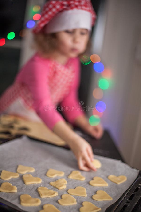 Ragazza felice che prepara i biscotti nella cucina, foto casuale in realtà interna, biscotti di natale, bambino di stile di vita fotografia stock Ragazza felice che prepara i biscotti nella cucina, foto casuale in realtà interna, biscotti di natale, bambino di stile di vita fotografia stock