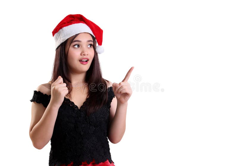 Ragazza sorpresa di Natale che indica al copyspace immagine stock libera da diritti Ragazza sorpresa di Natale che indica al copyspace immagine stock libera da diritti