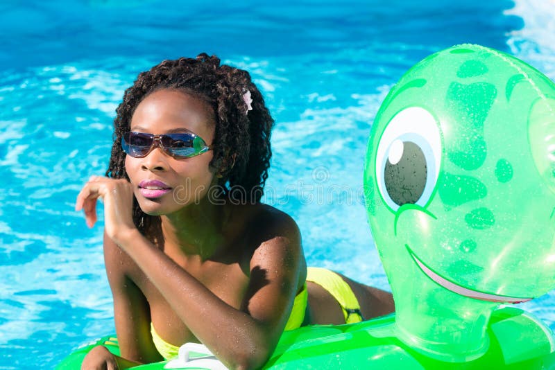 Ragazze in acqua della piscina con anmimal gonfiabile immagine stock Ragazze in acqua della piscina con anmimal gonfiabile immagine stock