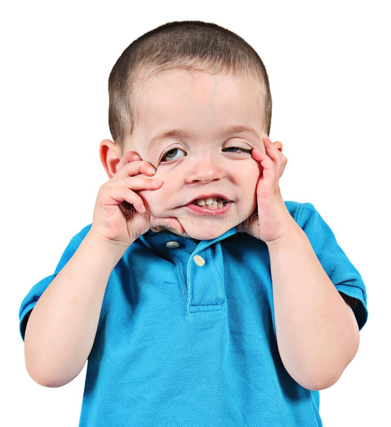 Young preschool, boy or toddler pulling funny or comical face; isolated on white background. Young preschool, boy or toddler pulling funny or comical face; isolated on white background.