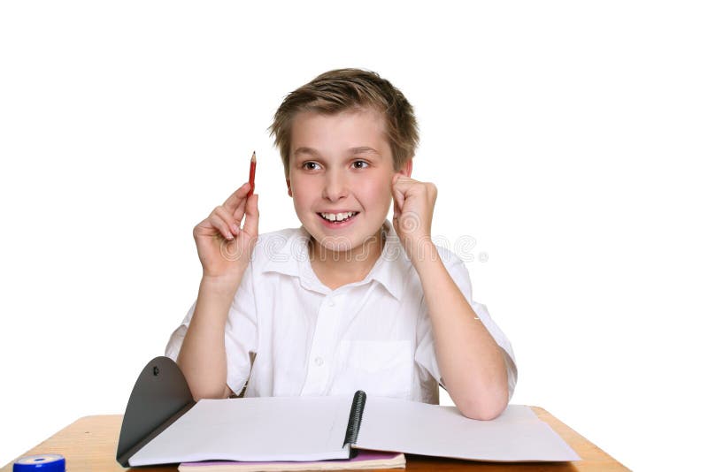 Happy school student sitting at desk with an idea or answer. Happy school student sitting at desk with an idea or answer.