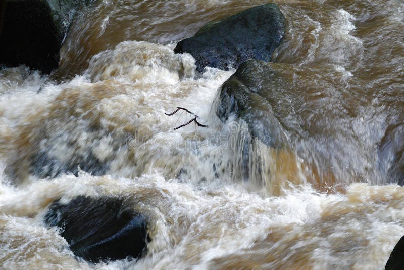 Raging water in rocky river.