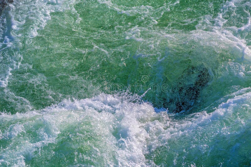 Raging water in whirpool of the mountain river