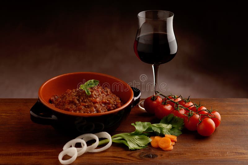 Ragu in bowl and red wine stock photo. Image of meat 12752110