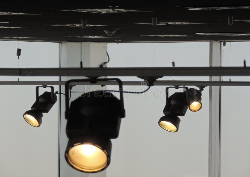 Tracking Spotlights Shines on the Ceiling Rail System Stock Photo