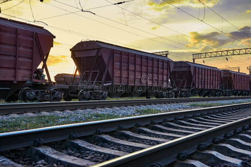 Railcar for dry cargo during beautiful sunset and colorful sky, railroad infrastructure, transportation and industrial concept stock photography Railcar for dry cargo during beautiful sunset and colorful sky, railroad infrastructure, transportation and industrial concept stock photography