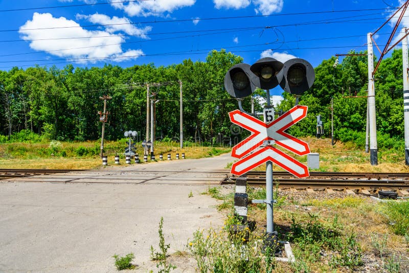 Railroad Crossing Sign and Semaphore in Front of the Railroad Crossing
