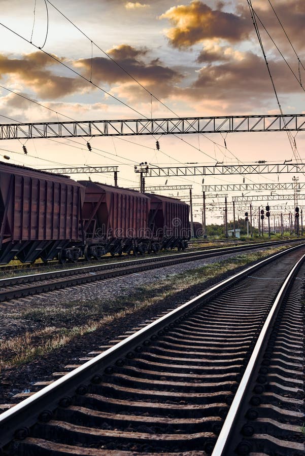 Railroad infrastructure during beautiful sunset and colorful sky, railcar for dry cargo, transportation and industrial concept royalty free stock photography Railroad infrastructure during beautiful sunset and colorful sky, railcar for dry cargo, transportation and industrial concept royalty free stock photography