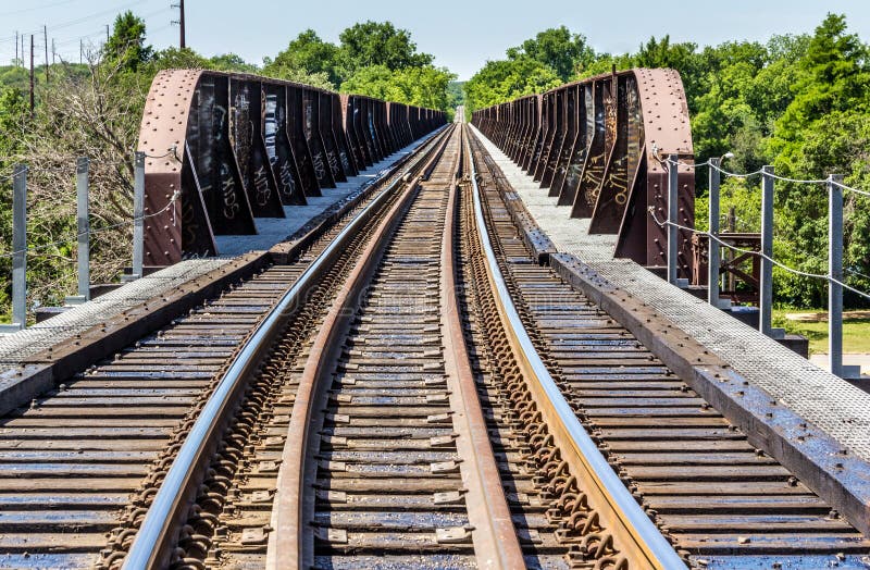 Railroad Tracks into the Distance and a Trestle Stock Photo Image of