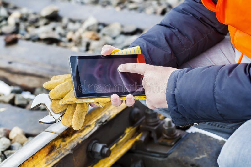 Railroad worker using tablet PC on railway