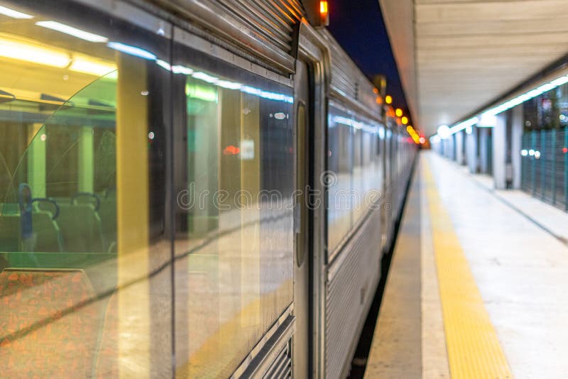 Railway Station with Train Carriages on the Left and a Deep Corridor on