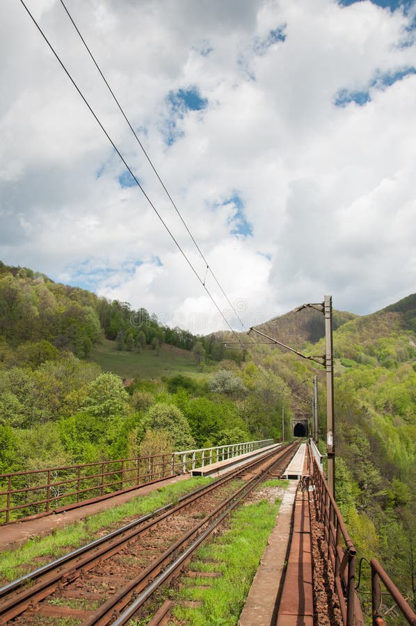 Railway tracks heading towards a tunnel