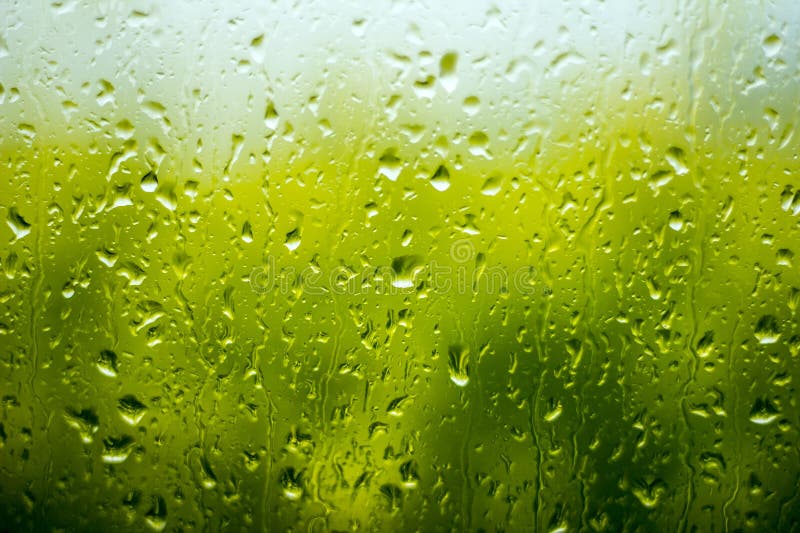 Rain drops on the window on the green background. Window color reflection background stock images, royalty-free photos and pictures